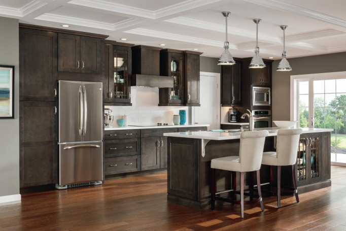 Modern kitchen with dark wood cabinets and island seating. 